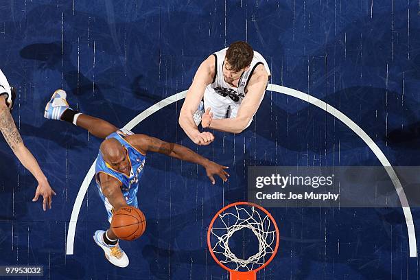 Chauncey Billups of the Denver Nuggets shoots a layup against Marc Gasol of the Memphis Grizzlies during the game at the FedExForum on March 13, 2010...