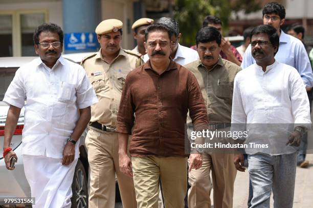 Makkal Needhi Maiam President Kamal Haasan with senior party members after a meeting with Election Commission officials to formally register his...