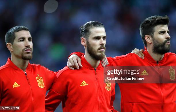 Sergio Ramos, David De Gea and Gerard Pique of Spain look on during the national anthem prior to the 2018 FIFA World Cup Russia group B match between...