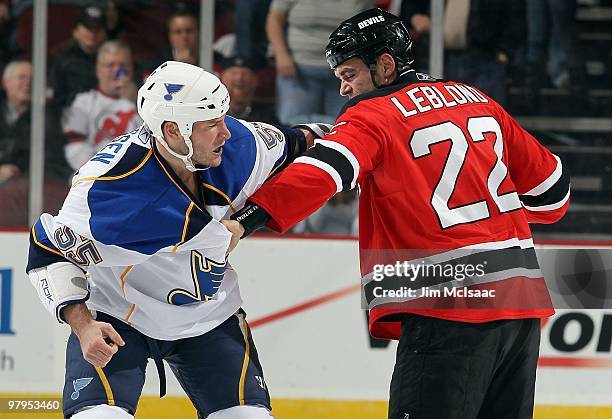 Cam Janssen of the St. Louis Blues trades punches with Pierre-Luc Letourneau-Leblond of the New Jersey Devils during their first period fight at the...