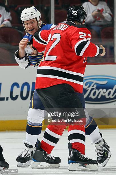 Cam Janssen of the St. Louis Blues trades punches with Pierre-Luc Letourneau-Leblond of the New Jersey Devils during their first period fight at the...