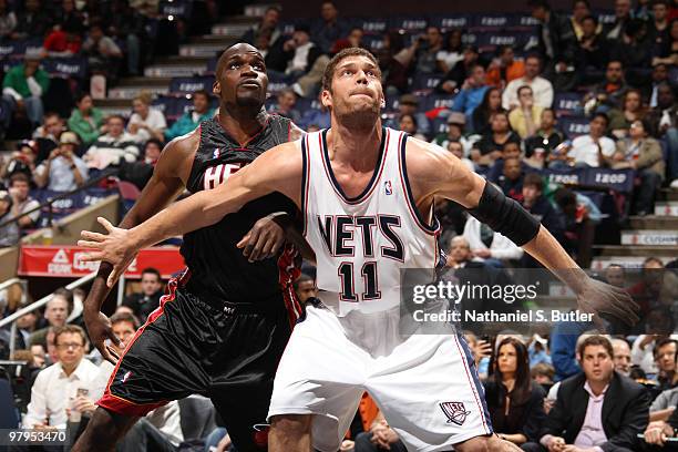 Brook Lopez of the New Jersey Nets defends against Joel Anthony of the Miami Heat on March 22, 2010 at the IZOD Center in East Rutherford, New...