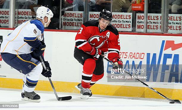 Zach Parise of the New Jersey Devils skates against Barret Jackman of the St. Louis Blues at the Prudential Center on March 20, 2010 in Newark, New...