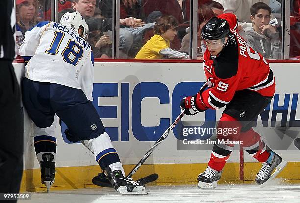 Zach Parise of the New Jersey Devils skates against Jay McClement of the St. Louis Blues at the Prudential Center on March 20, 2010 in Newark, New...