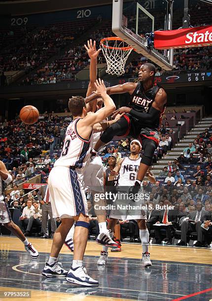 Dwyane Wade of the New Jersey Nets passes against Kris Humphries of the Miami Heat on March 22, 2010 at the IZOD Center in East Rutherford, New...