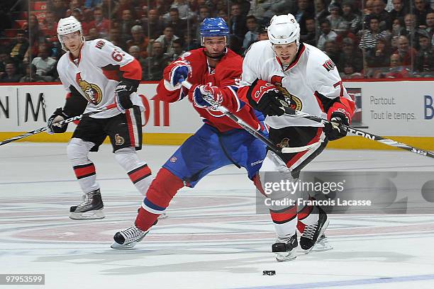 Benoit Pouliot of the Montreal Canadiens battles for the puck with Jarkko Ruutu of the Ottawa Senators during the NHL game on March 22, 2010 at the...