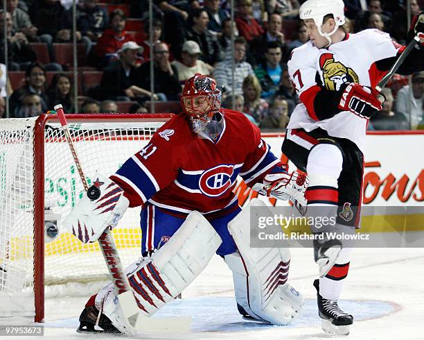 Jaroslav Halak of the Montreal Canadiens makes a blocker save on the puck in front of Zack Smith of the Ottawa Senators during the NHL game on March...