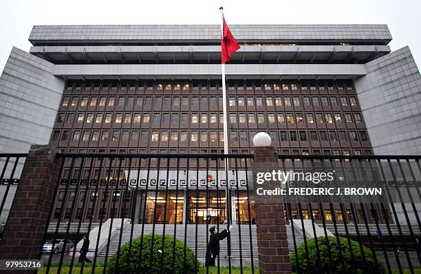 The Chinese national flag is raised in front of the Shanghai No.1 Intermediate People's Court in Shanghai on March 23, 2010 where the diplomatically...