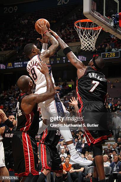 Terrence Williams of the New Jersey Nets shoots against Jermaine O'Neal of the Miami Heat on March 22, 2010 at the IZOD Center in East Rutherford,...