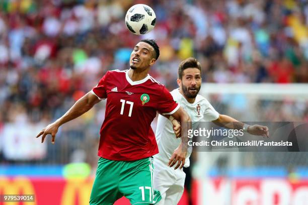 Nabil Dirar of Morocco and Joao Moutinho of Portugal jump for a header during the 2018 FIFA World Cup Russia group B match between Portugal and...