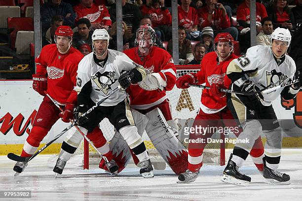 Jimmy Howard of the Detroit Red Wings and teammates Brad Stuart and Niklas Kronwall tie up Bill Guerin of the Pittsburgh Penguins & teammate Alexei...
