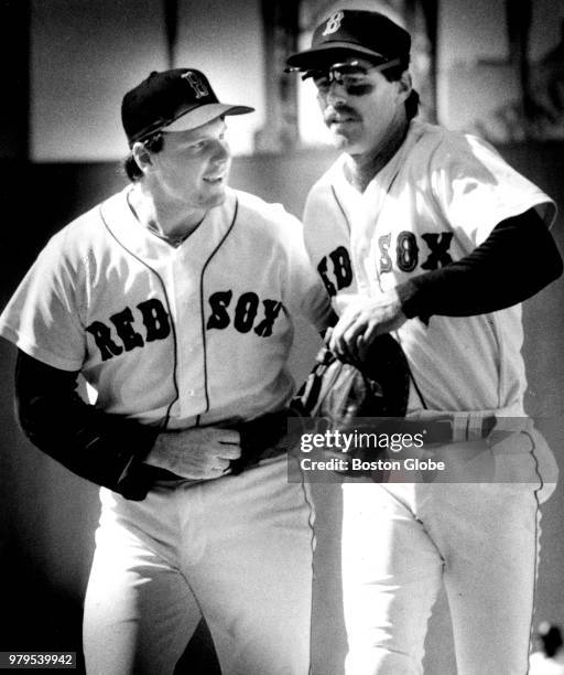 Boston Red Sox players Roger Clemens and Bill Buckner leave the field after the top of the eighth inning during a game between the Boston Red Sox the...