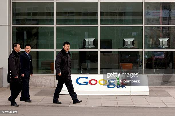 Security guards walk outside the Google Inc. Office in Beijing, China, on Tuesday, March 23, 2010. Google Inc., following through on a pledge to stop...