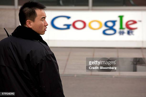 Security guard walks outside the Google Inc. Office in Beijing, China, on Tuesday, March 23, 2010. Google Inc., following through on a pledge to stop...