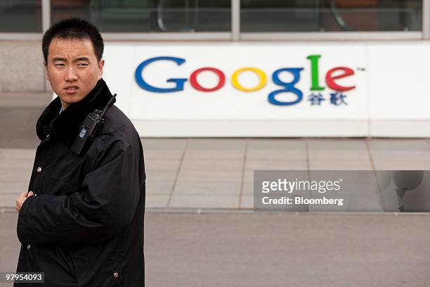 Security guard walks outside the Google Inc. Office in Beijing, China, on Tuesday, March 23, 2010. Google Inc., following through on a pledge to stop...