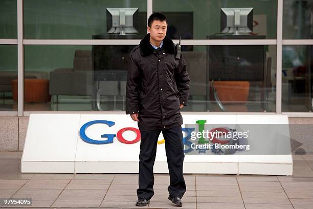 Security guard walks outside the Google Inc. Office in Beijing, China, on Tuesday, March 23, 2010. Google Inc., following through on a pledge to stop...