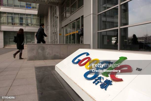 People arrive at the Google Inc. Office in Beijing, China, on Tuesday, March 23, 2010. Google Inc., following through on a pledge to stop censoring...