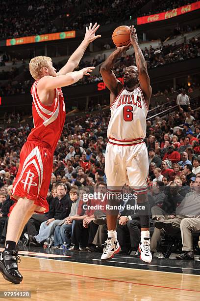 Ronald Murray of the Chicago Bulls shoots a jumper as Chase Budinger of the Houston Rockets moves in to block during the NBA game on March 22, 2010...