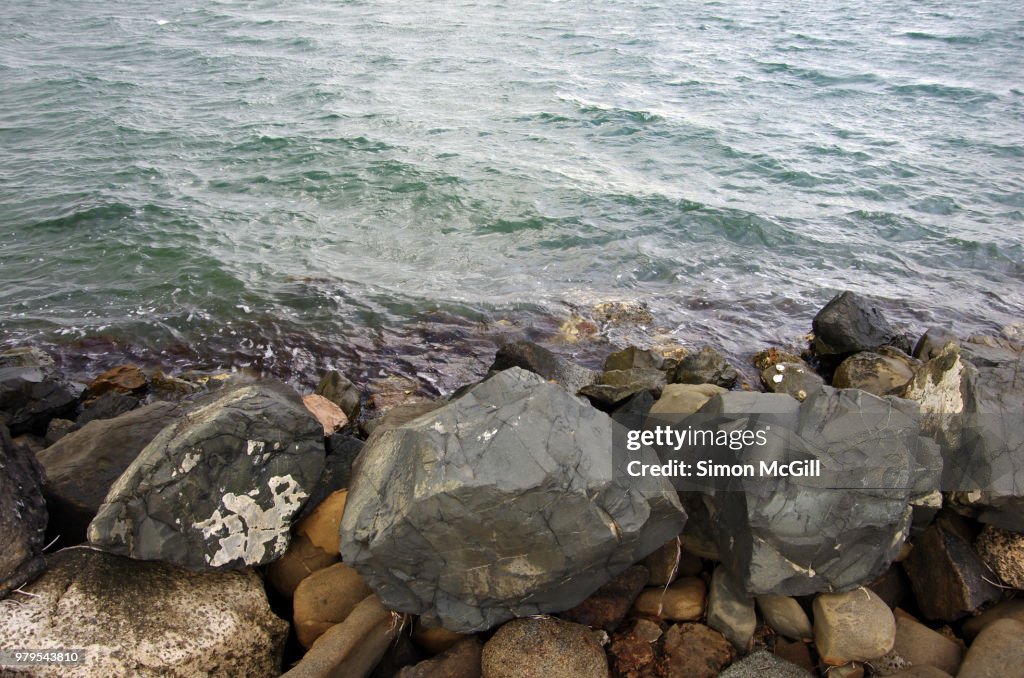 Rock breakwater on the edge of Lake Illawarra, New South Wales, Australia
