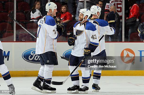 Mike Weaver and Keith Tkachuk of the St. Louis Blues celebrate after defeating the New Jersey Devils at the Prudential Center on March 20, 2010 in...