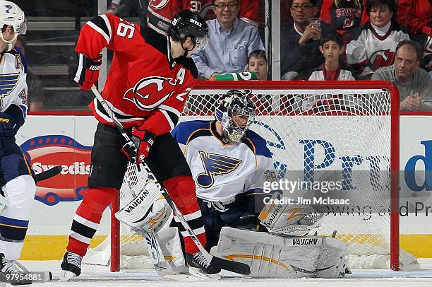 Ty Conklin of the St. Louis Blues defends against Patrik Elias of the New Jersey Devils at the Prudential Center on March 20, 2010 in Newark, New...