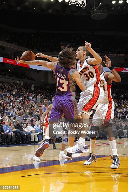 Stephen Curry of the Golden State Warriors blocks Steven Nash of the Phoenix Suns on March 22, 2010 at Oracle Arena in Oakland, California. NOTE TO...