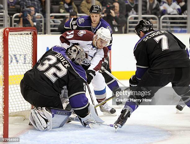 Galiardi of the Colorado Avalanche comes around the net for a scoring chance in front of Jonathan Quick and Rob Scuderi of the Los Angeles Kings...