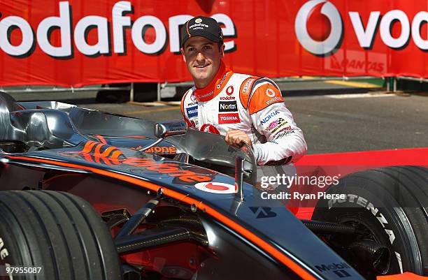 Jamie Whincup of the Vodafone V8 Supercars Team poses with the McLaren of Jenson Button of Vodafone McLaren Mercedes F1 Team during previews for the...