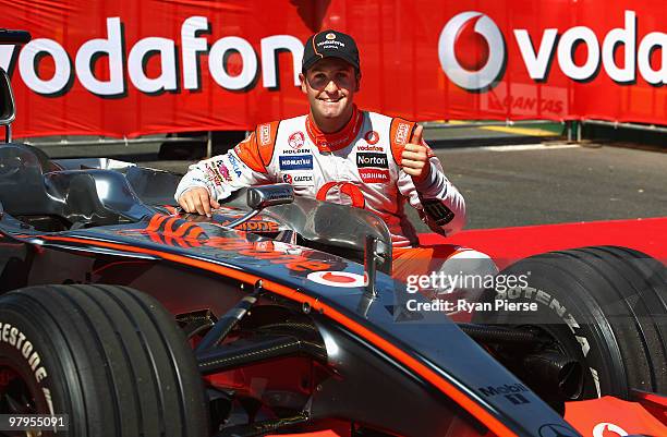 Jamie Whincup of the Vodafone V8 Supercar Team poses with the McLaren of Jenson Button of Vodafone McLaren Mercedes F1 Team during previews for the...