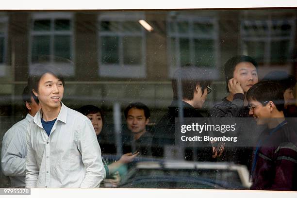 Employees look at the awaiting media after a company meeting at the Google Inc. Office in Beijing, China, on Tuesday, March 23, 2010. Google Inc.'s...