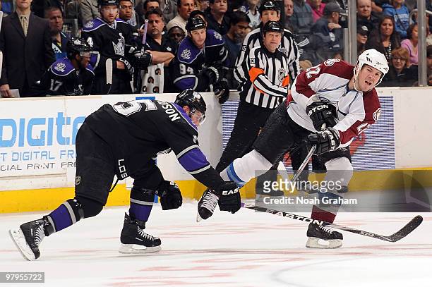 Scott Hannan of the Colorado Avalanche passes around Brad Richardson of the Los Angeles Kings on March 22, 2010 at Staples Center in Los Angeles,...