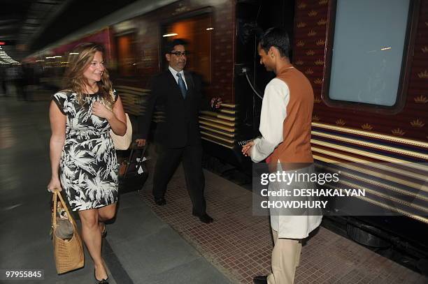 Lifestyle-India-tourism-rail-travel, FOCUS by Sailendra Sil An Indian train assistant welcomes a British tourist to the Maharajas' Express, the first...