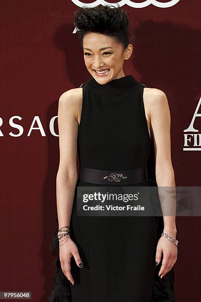 Chinese actress Zhou Xun smiles as she poses at the red carpet for the 4th Asian Film Awards ceremony at the Convention and Exhibition Centre on...