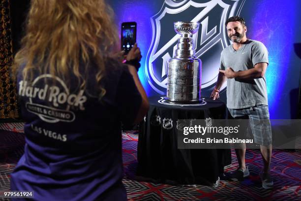 Fan gets his picture taken with the Stanley Cup on display ahead of the 2018 NHL Awards at the Hard Rock Hotel & Casino on June 17, 2018 in Las...