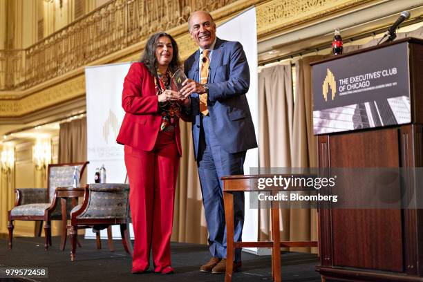 Muhtar Kent, chairman of the Coca-Cola Co., stands for a photograph with Ana Dutra, president of the Executives Club of Chicago, on stage during an...