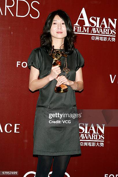 South Korea's Park Eun-kyo holds her best screenwriter award during the 4th Asian Film Awards Ceremony at the Convention and Exhibition Centre on...