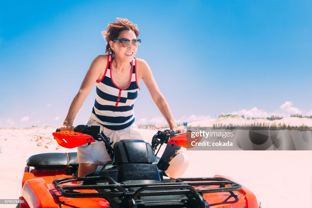 Adult woman driving off road ATV