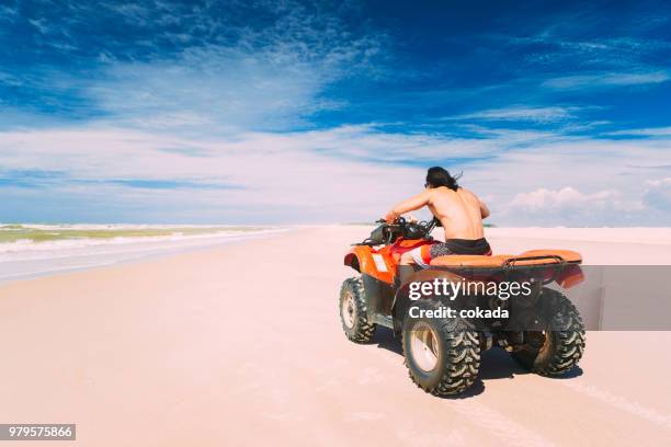 young man driving off road atv - dune buggy stock pictures, royalty-free photos & images