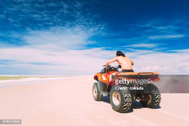 young man driving off road atv - lencois maranhenses national park stock pictures, royalty-free photos & images