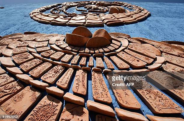 Picture taken on March 19, 2010 shows "La porta della Bellezza" , 9.000 shapes of terracotta made by 2.000 children, on a wall of a street in the...