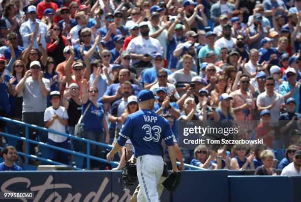 Happ of the Toronto Blue Jays receives an ovation from the crowd as he exits the game after being relieved in the ninth inning against the Atlanta...