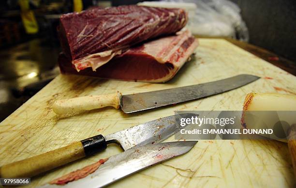 Tools used to cut a bluefin tuna's belly into pieces, sit on a counter, as the large fish was prepared in order to provide it to New York's top sushi...