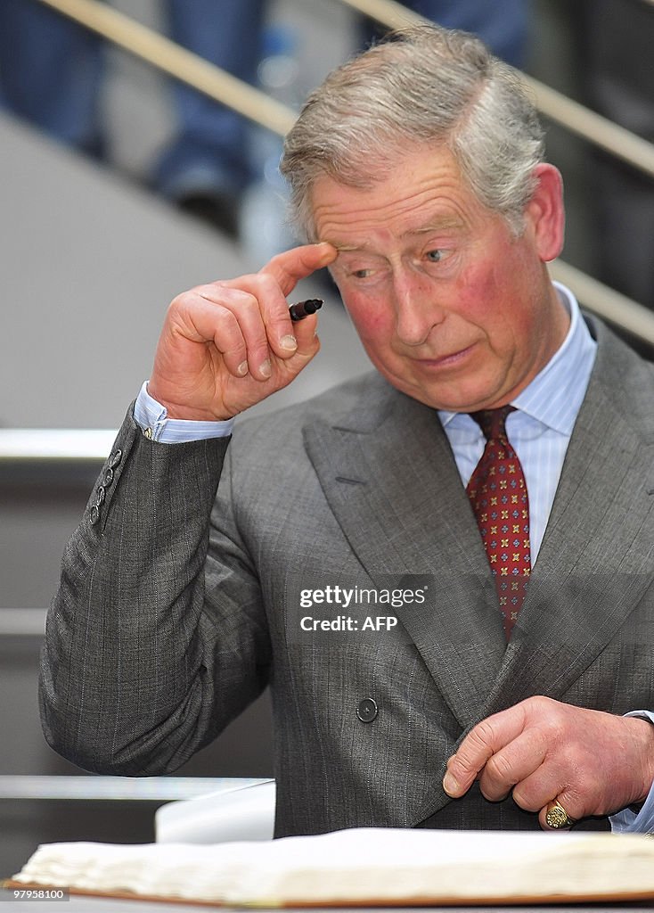 Britain's Prince Charles prepares to sig