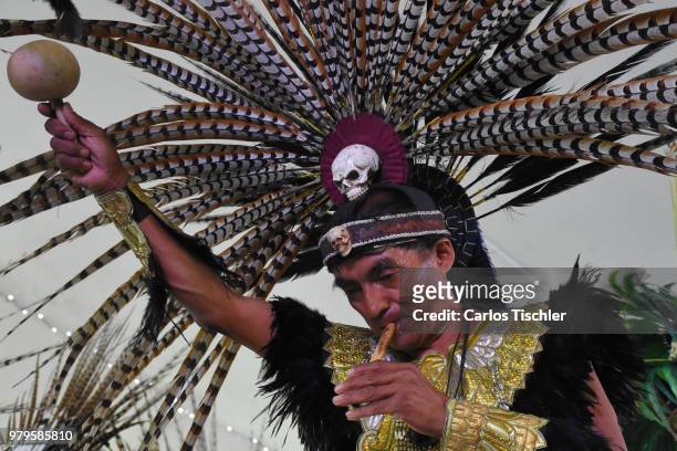 Man dress as indigenous mexican plays the flute during a meeting with indigenous groups at Fuego Nuevo Archaelogical Museum on June 18, 2018 in...