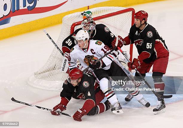 Jonathan Toews of the Chicago Blackhawks is defended by Zbynek Michalek and Ed Jovanovski of the Phoenix Coyotes during the NHL game at Jobing.com...