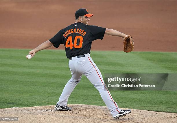 Starting pitcher Madison Bumgarner of the San Francisco Giants pitches against the Texas Rangers during the MLB spring training game at Surprise...