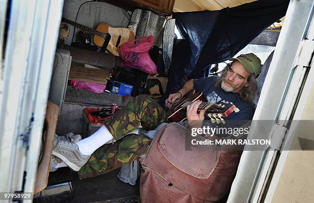 Kyle MacDowell who has no health insurance and lives in an RV since losing his job as a grip in the film industry, sings a song he wrote about...