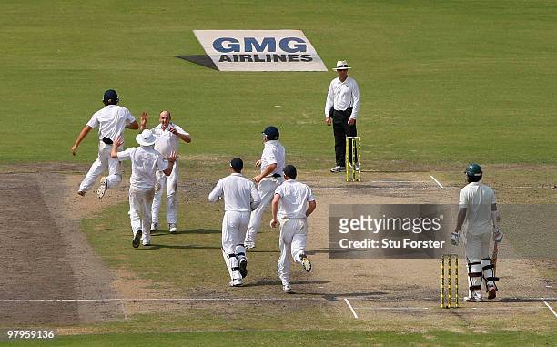 England captain Alastair Cook celebrates after deflecting a ball hit by Bangladesh batsman Junaid Siddique to be caught by bowler James Tredwell...