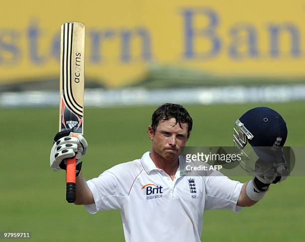 England cricketer Ian Bell raises his bat on scoring a century during the third day of the second Test match between Bangladesh and England at the...