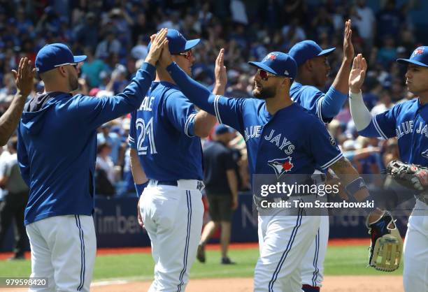 Kevin Pillar of the Toronto Blue Jays celebrates a victory with teammates against the Atlanta Braves at Rogers Centre on June 20, 2018 in Toronto,...